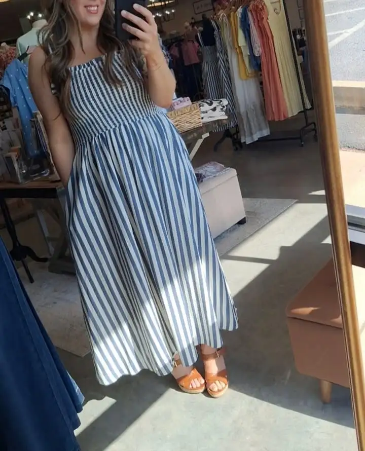 A striped maxi dress shown inside The Marketplace Boutique
