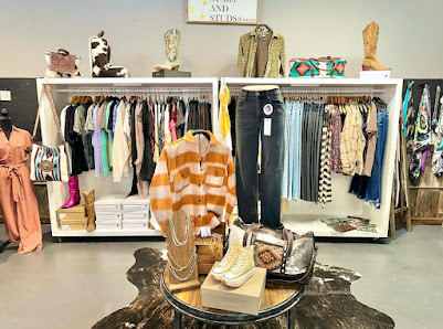 Clothing, boots, and bags arranged inside the boutique