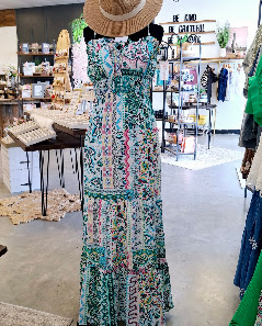 A floral maxi dress displayed inside the boutique
